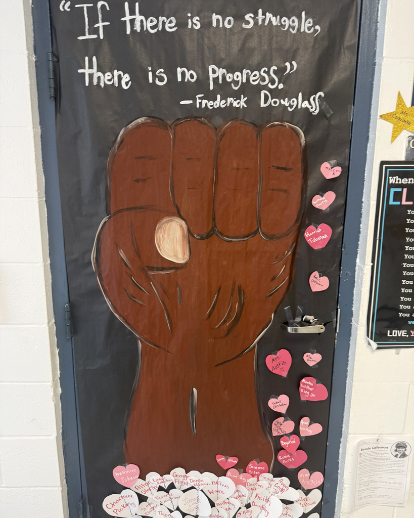 Black History Door Decorating Contest. Fist with hearts and quote "If there is no struggle, there is not progress."