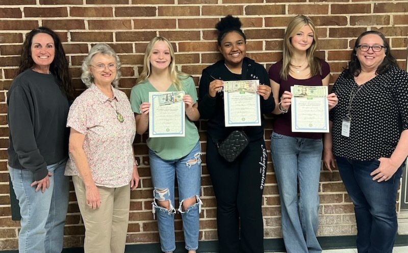 Photo #1 WHS Principal Michele Falk, contest chair Nancy Floyd Richardson and Jo Ann Daniels congratulate the WHS first, second and third place winners, Tristen Hubbell, Ashlyn Haynes and Scarlette Brown.