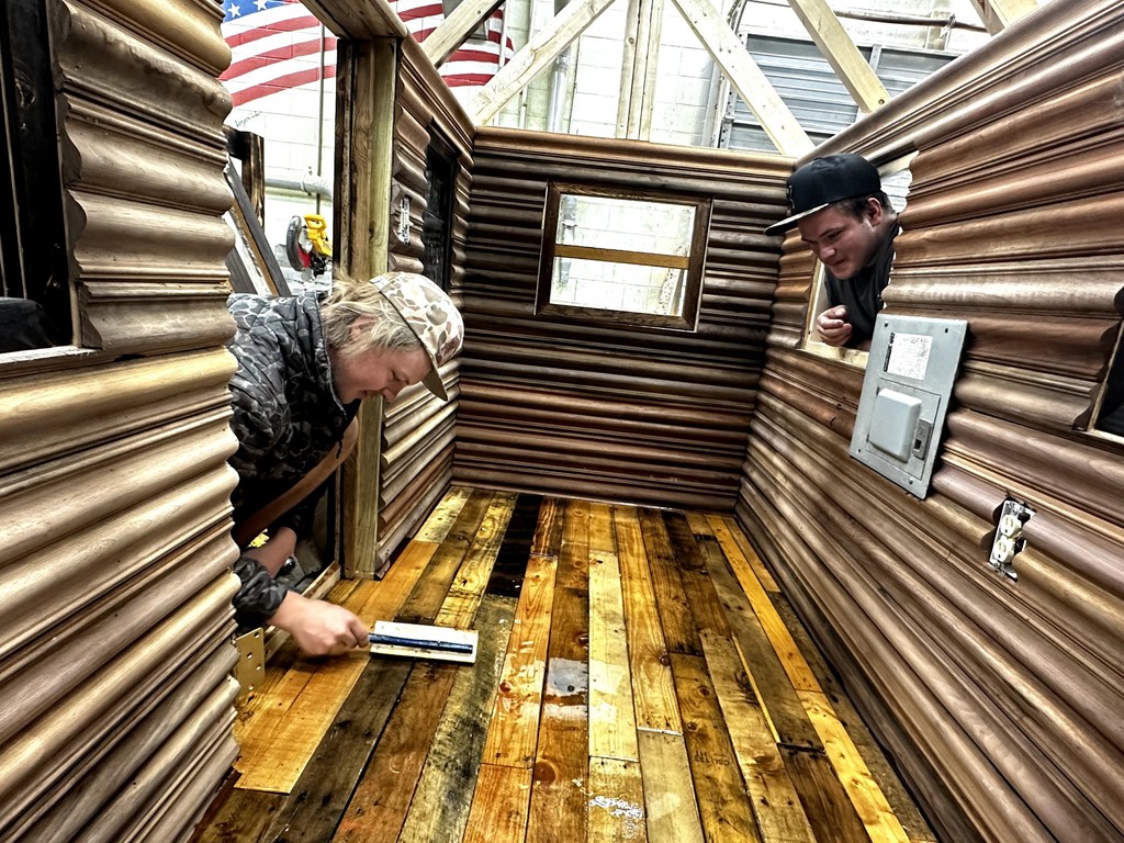 Carpentry students building a playhouse from the ground up.