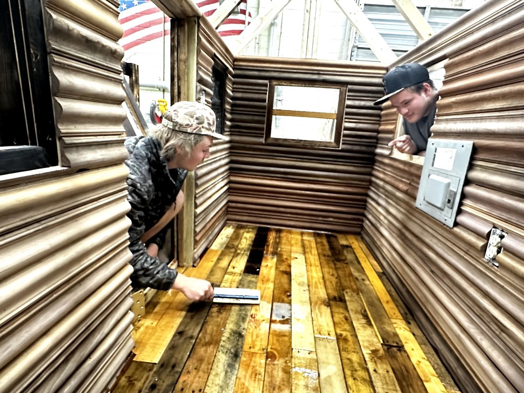 Carpentry students building a playhouse from the ground up.