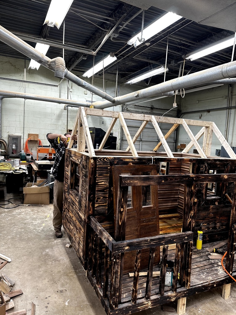 Carpentry students building a playhouse from the ground up.