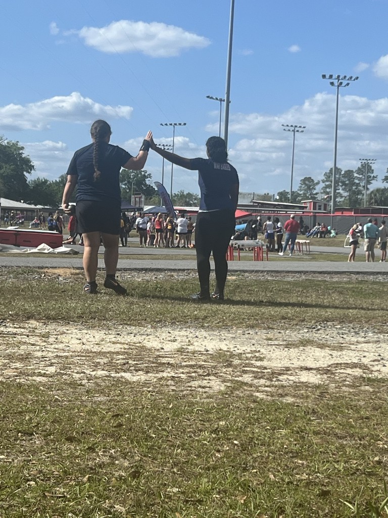 Track and field teammates high fiving