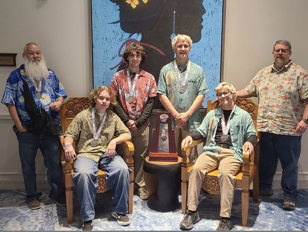 Academic team members posing with trophy