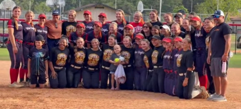 Middleburg and Wakulla High smiling for a picture with Ella on "Ella Night."