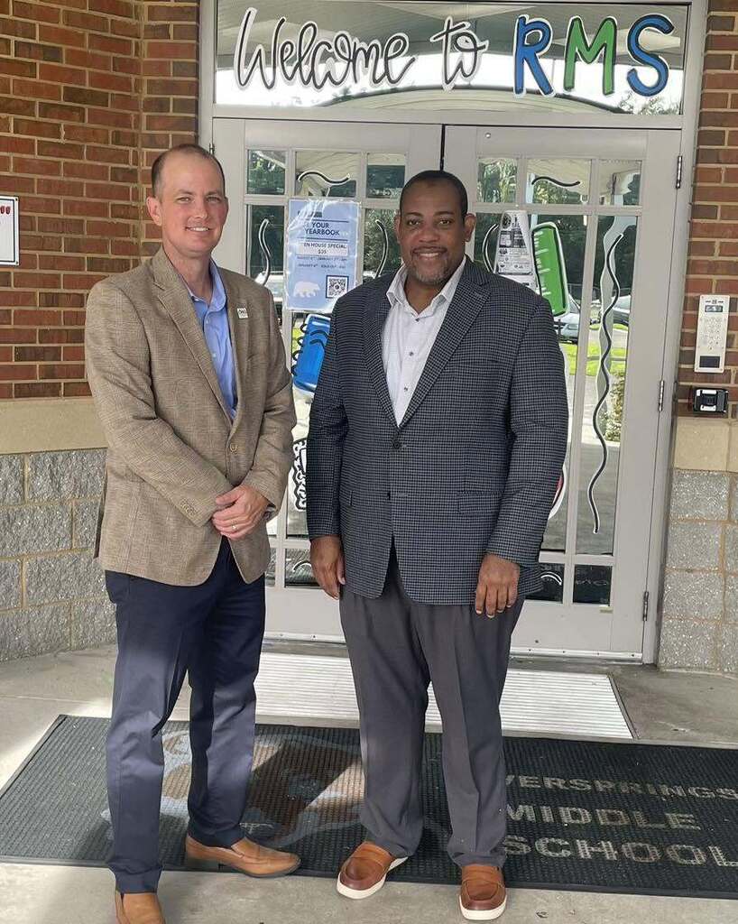 Wakulla County Schools Superintendent Rick Myhre and Florida Department of Education Senior Vice Chancellor Paul Burns stand together outside the entrance of Riversprings Middle School during a first-day-of-school visit.