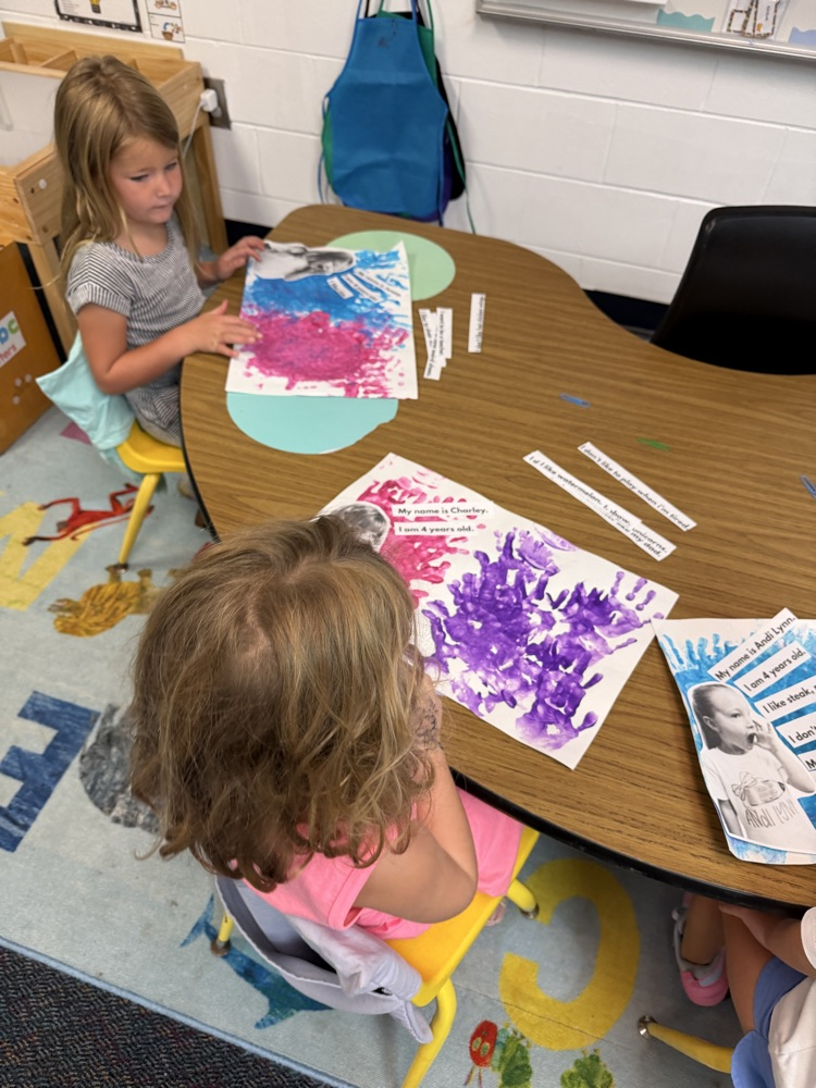 PreK students experiment with hands on materials to create an “All About Me” project about themselves 
