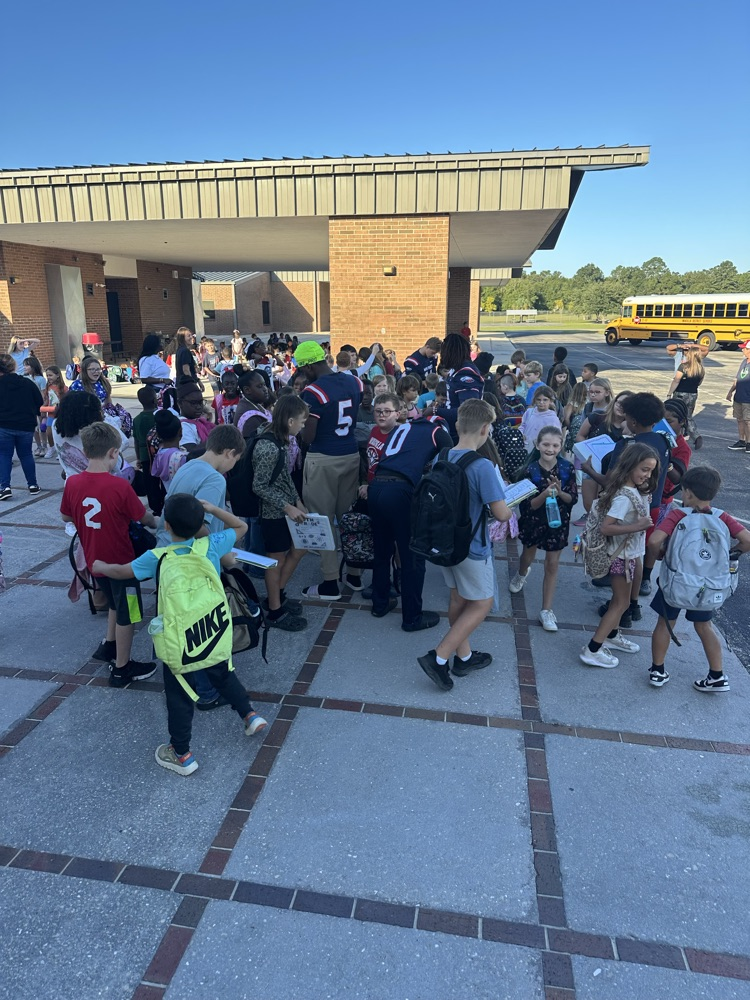 WHS Football Players and students on bus ramp 