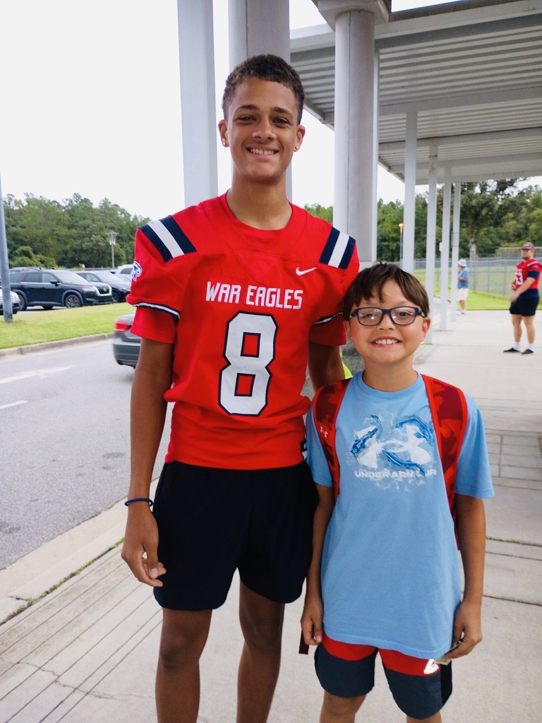 QB Aston Brookes smiling with a student.