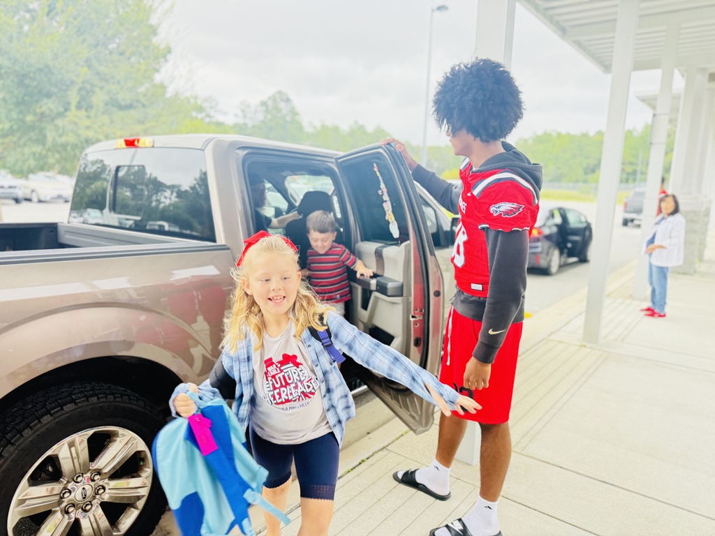 Football player opening a car door for a RES student