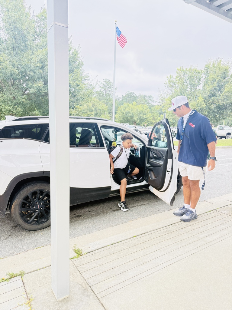 Coach Derek Allen opening a door for a RES student