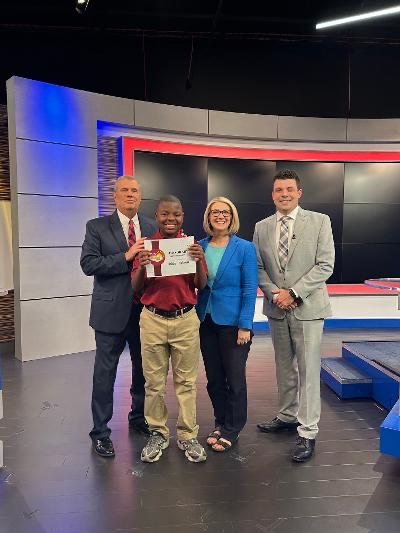student with news station crew