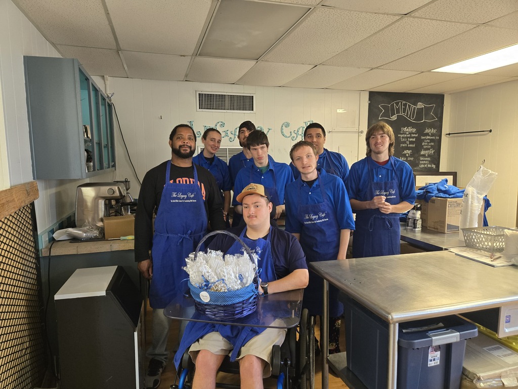 Mr. Simmons and students in the Legacy Cafe' with a basket of baked cookies