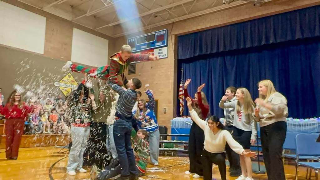 HS Choir from the winter concert, lifting Bradley up in celebration