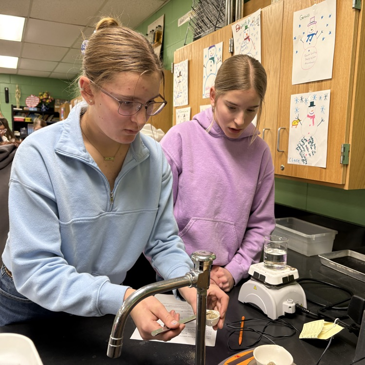 Sisters Heidi and Hazel  team up to conduct lab about convection and air currents.  
