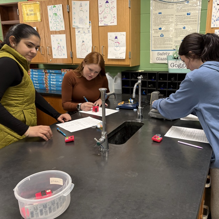chem students  conducting the removal of sugar from bubble gum lab