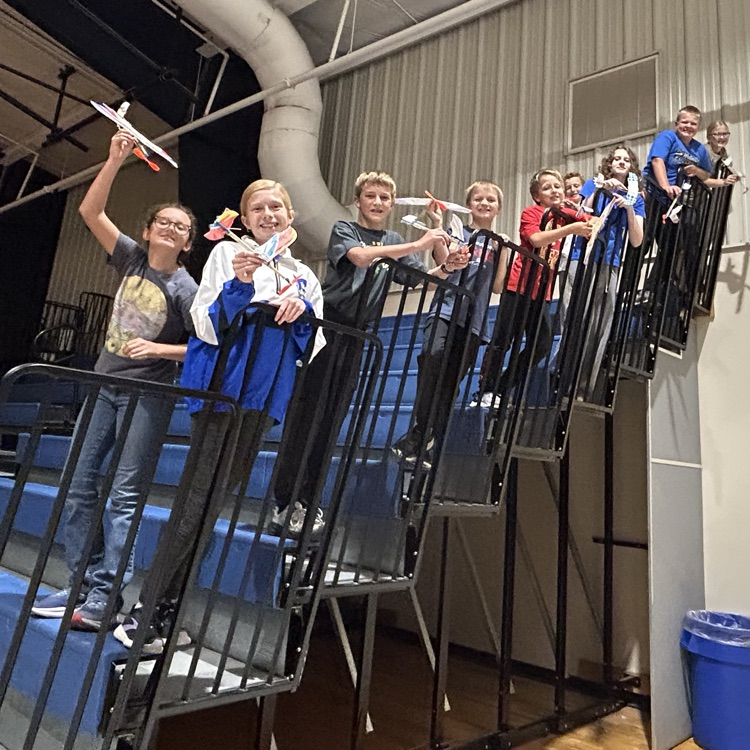 students with handmade airplanes