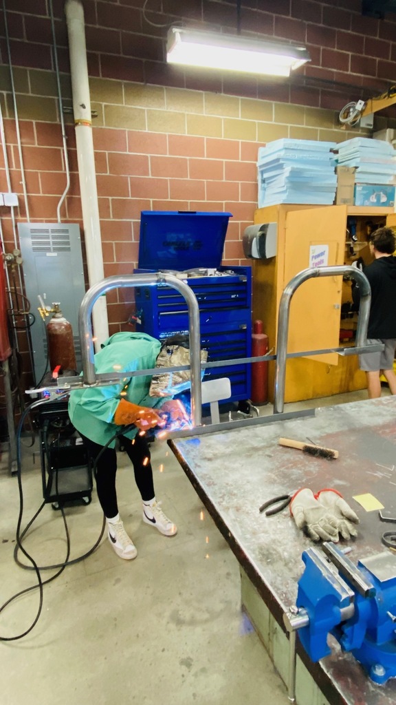 Female student welding.