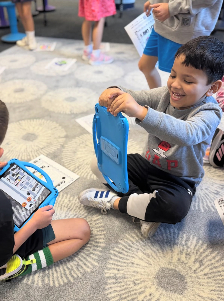 student with an iPad in STEM class