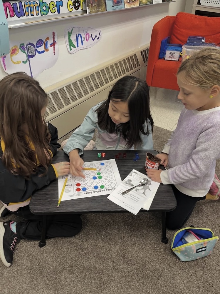 3 students engaged in buddy math