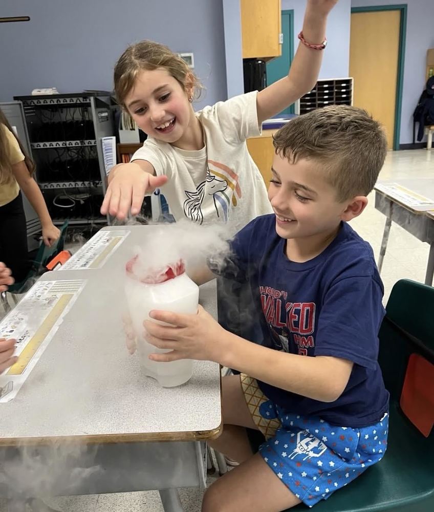 two students exploring dry ice