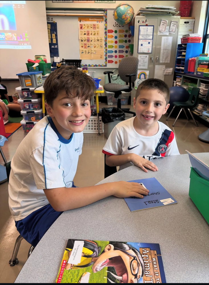 two students engaged in buddy class reading