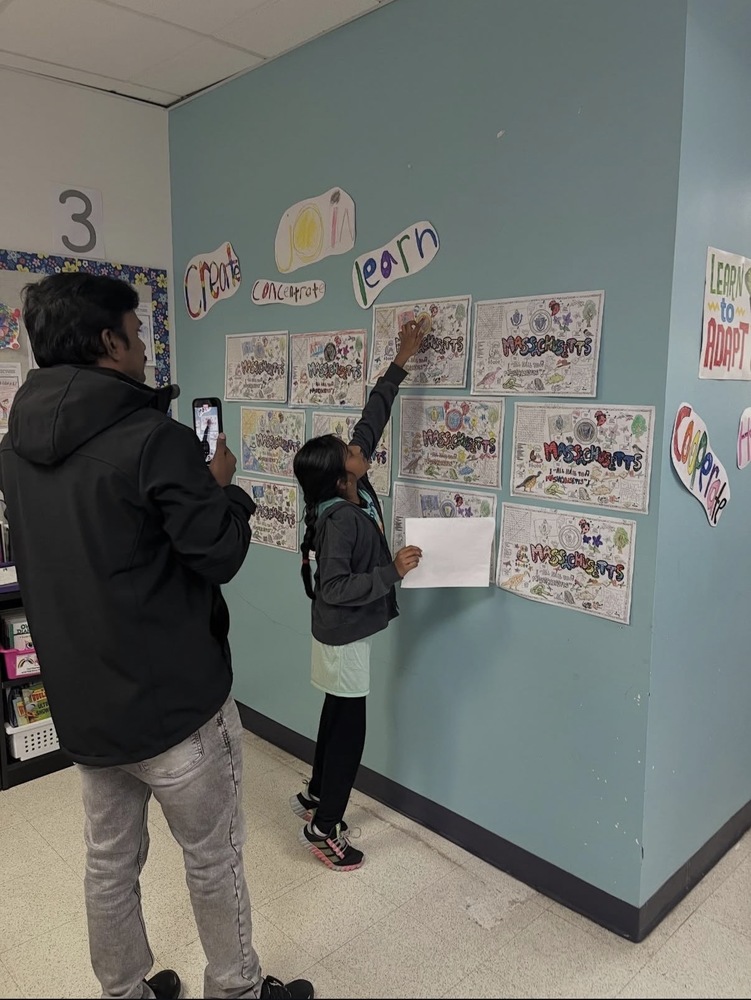 parent and child looking at work in a grade 3 classroom
