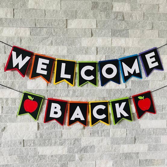 welcome back banner on a concrete block wall
