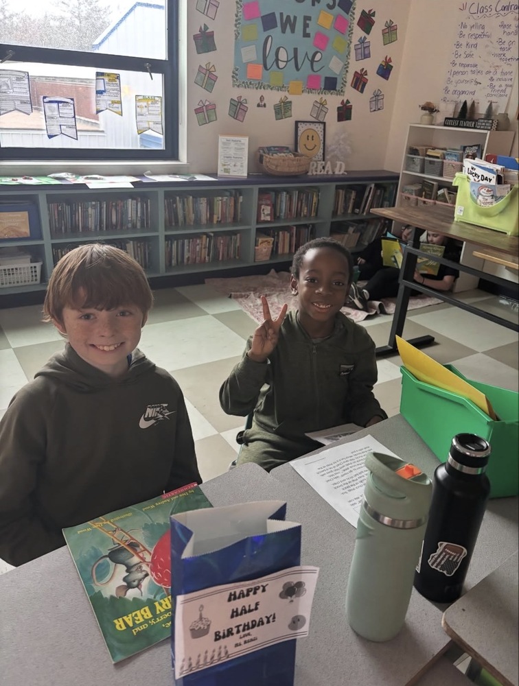 two students reading together in their buddy class