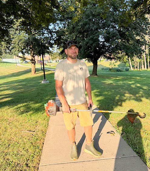 employee posing with lawn equipment 
