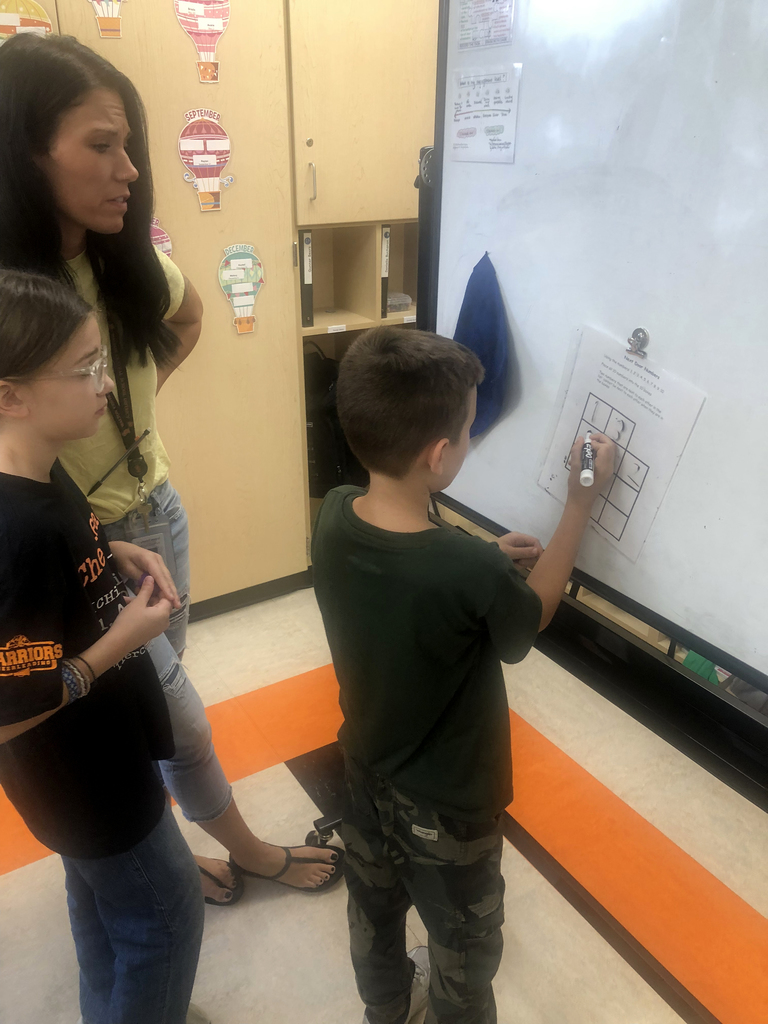 Students working together in the classroom. 