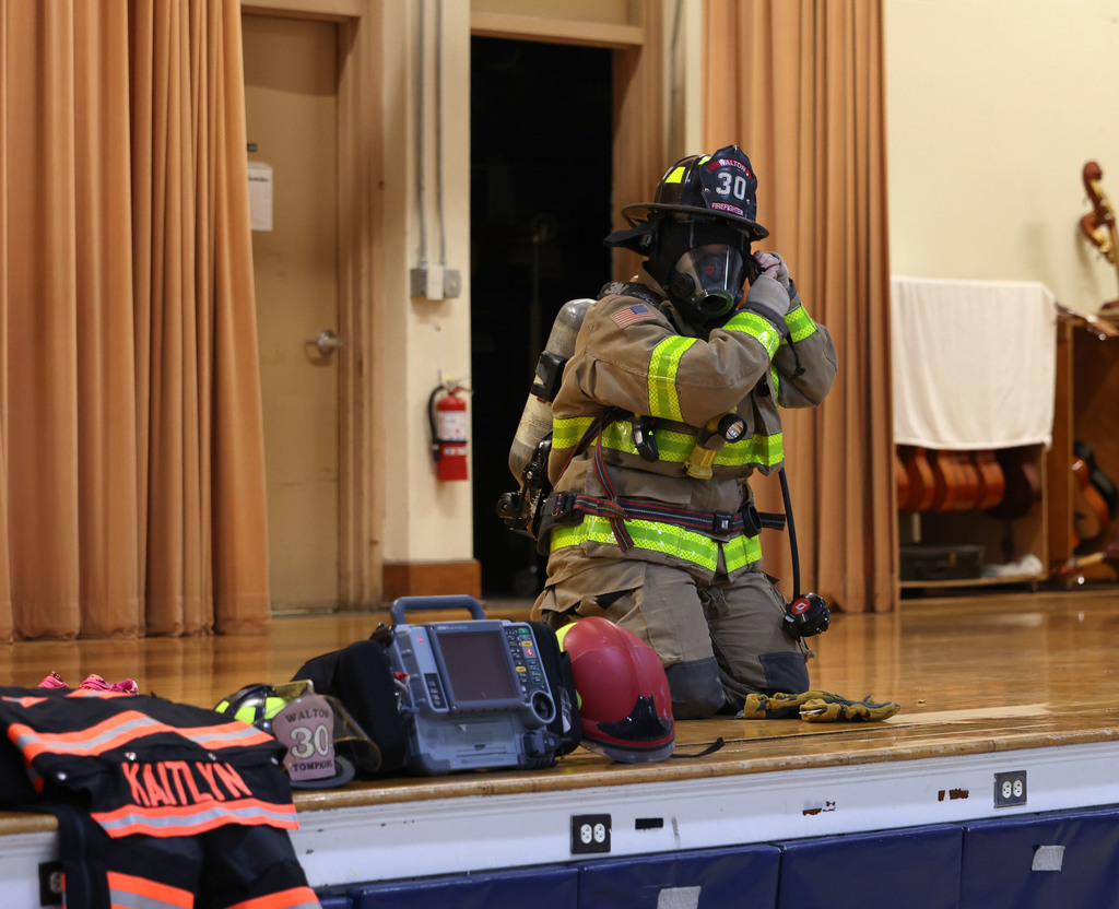 Walton firefighter showing Townsend students what it looks like in full gear. 