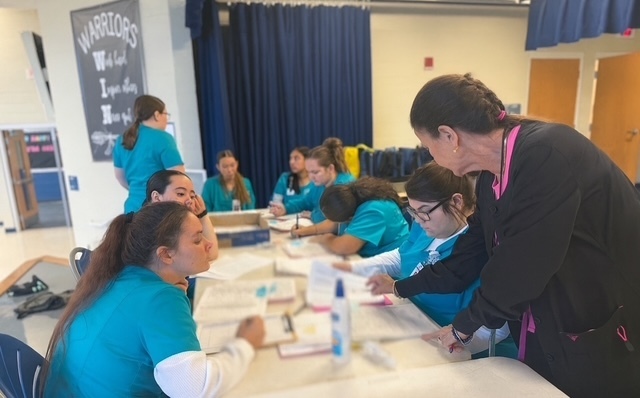 PCT students helping with health screenings at WMS