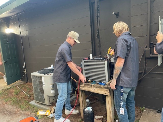 HVAC/R students working on a cooler