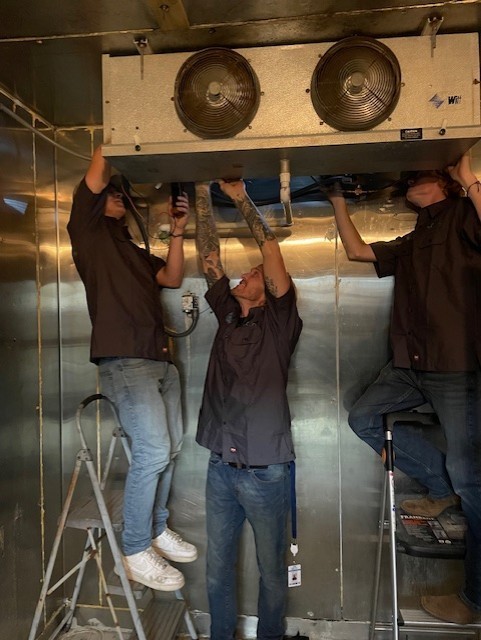 HVAC/R students working on a cooler