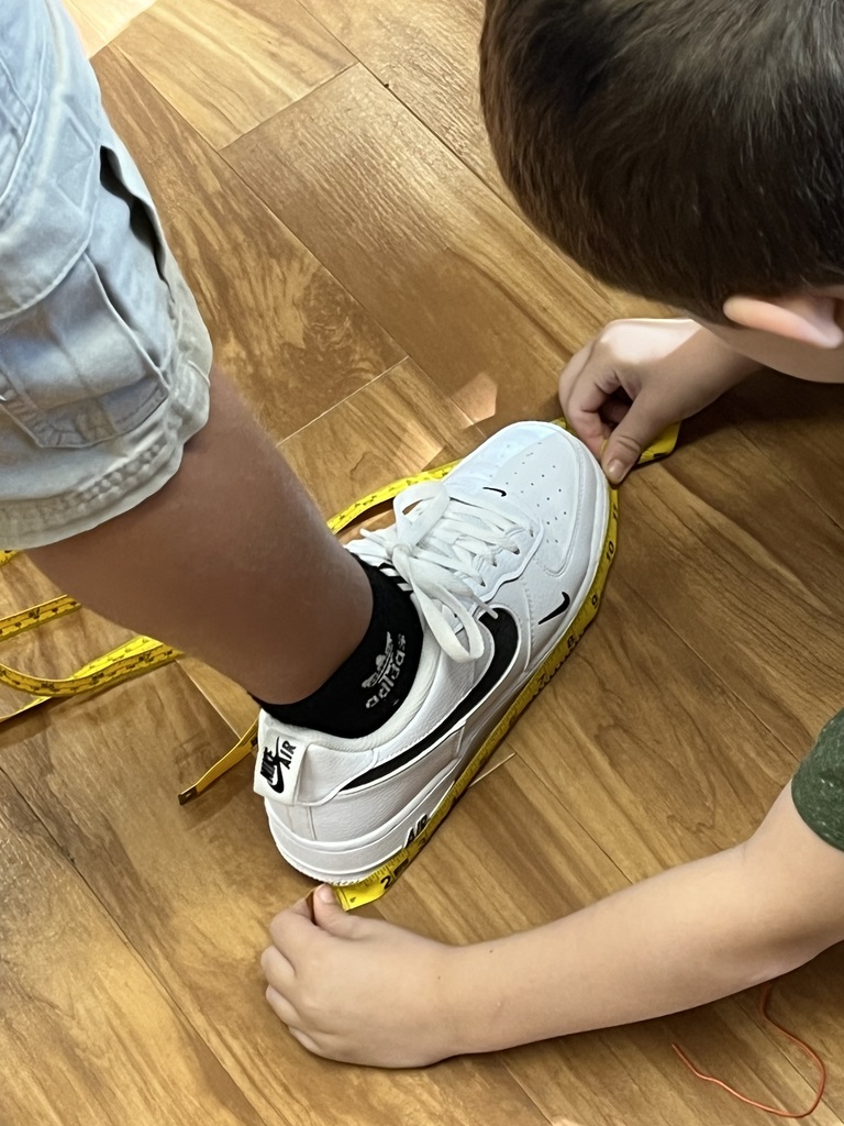 Third grade students learn how to use a tape measure in a fun activity working in pairs to measure lengths such as “wing span” among other things!