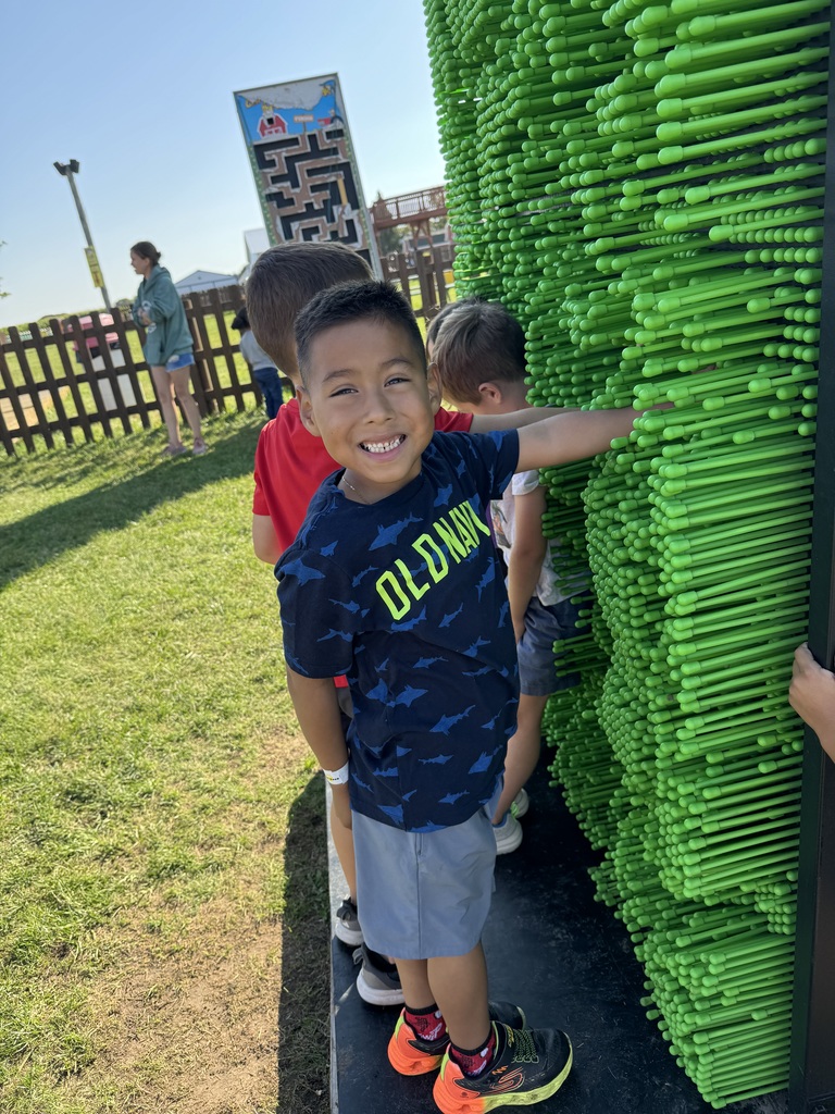 Student by a green wall