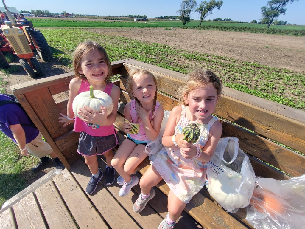 3 students and pumpkins
