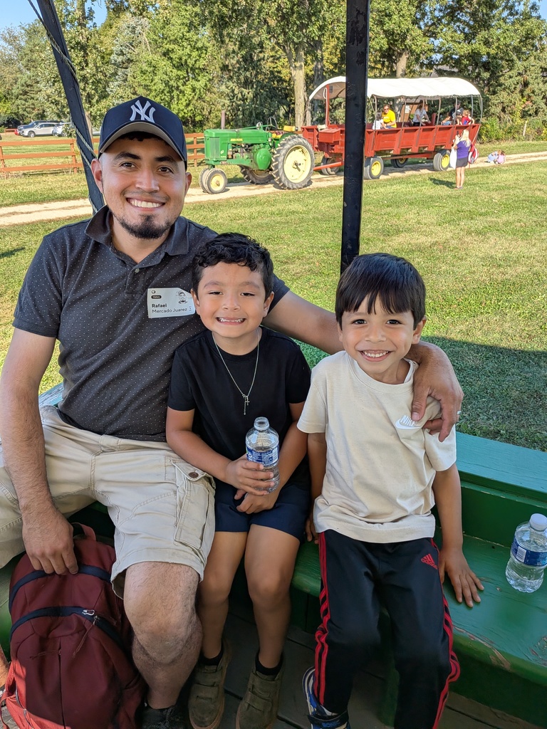 an adult and two children on a wagon ride