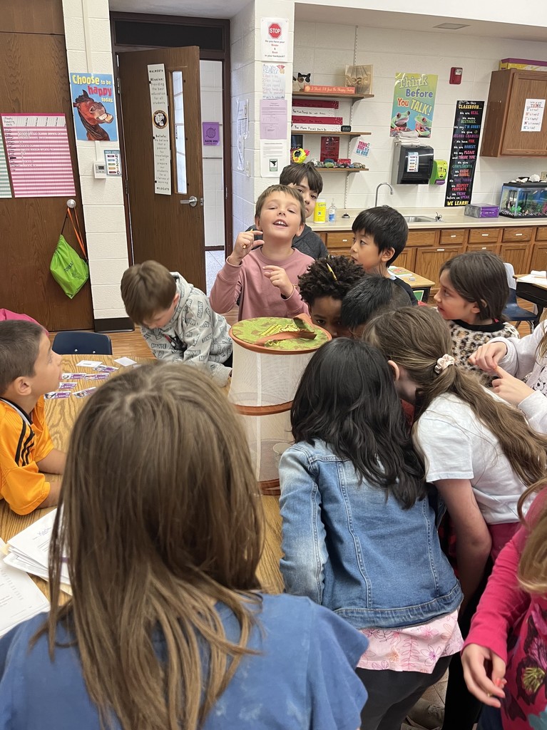 students observing a butterfly in a butterfly net