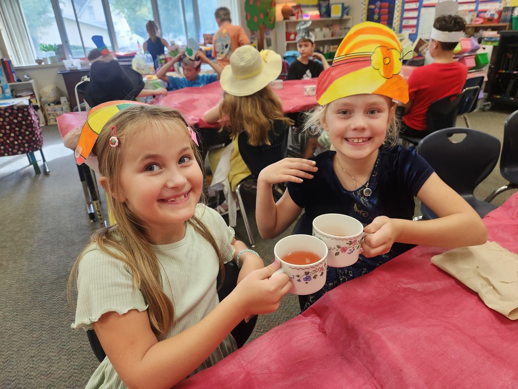 Two girls cheersing coffee mugs