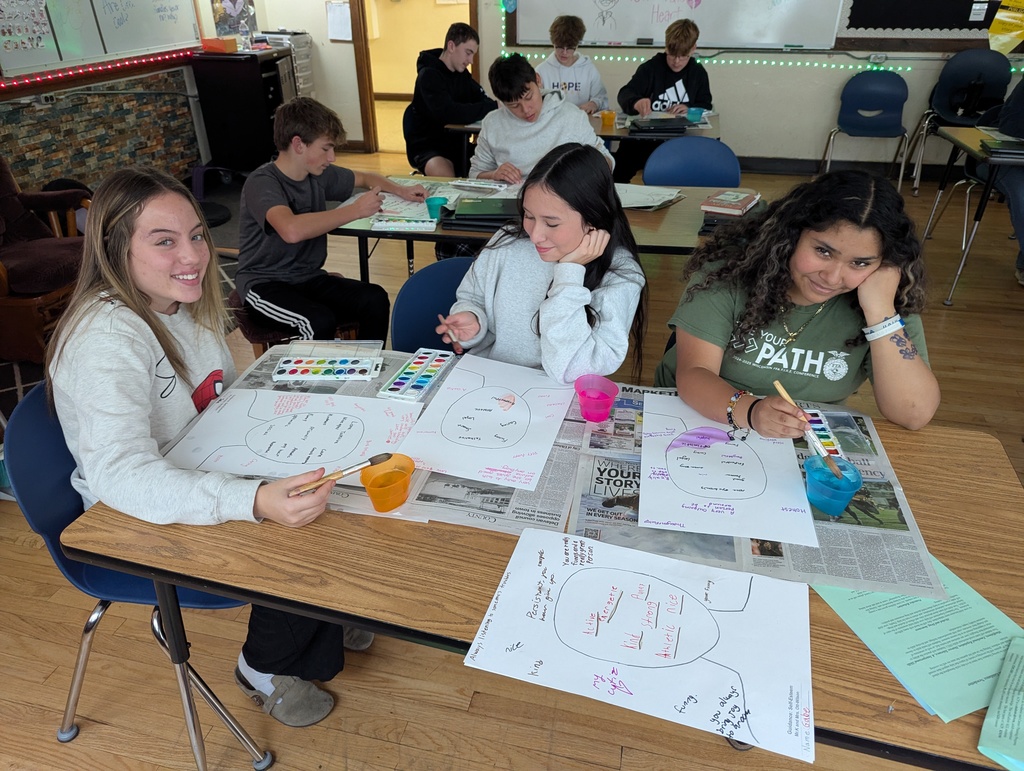 three students painting with watercolors