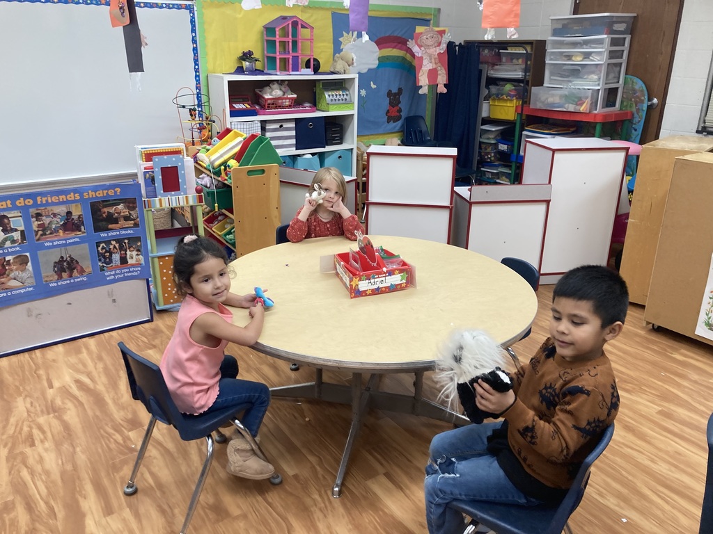 3 students playing with finger puppets