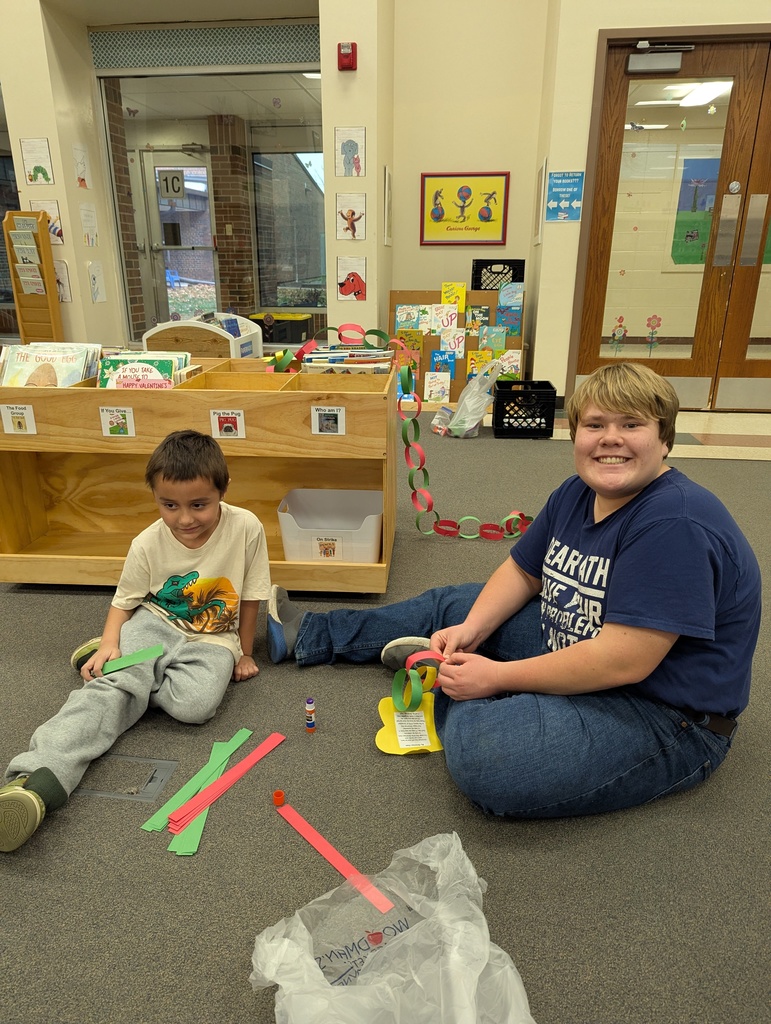 two students making a paper chain