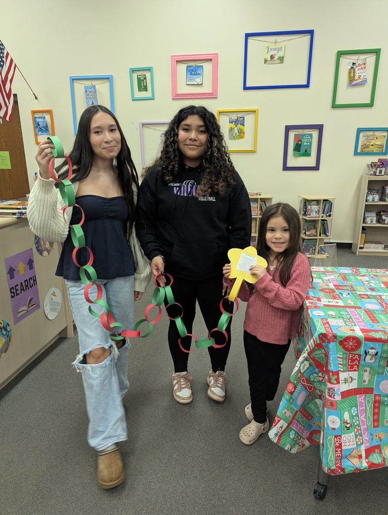 3 students with a paper chain