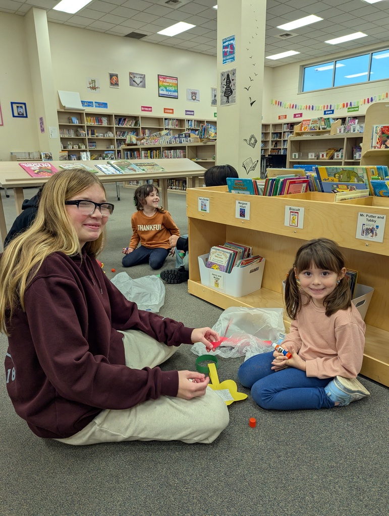 two students making a paper chain