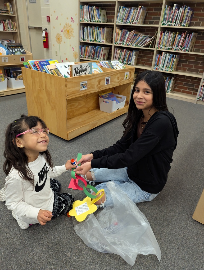 two students making a paper chain