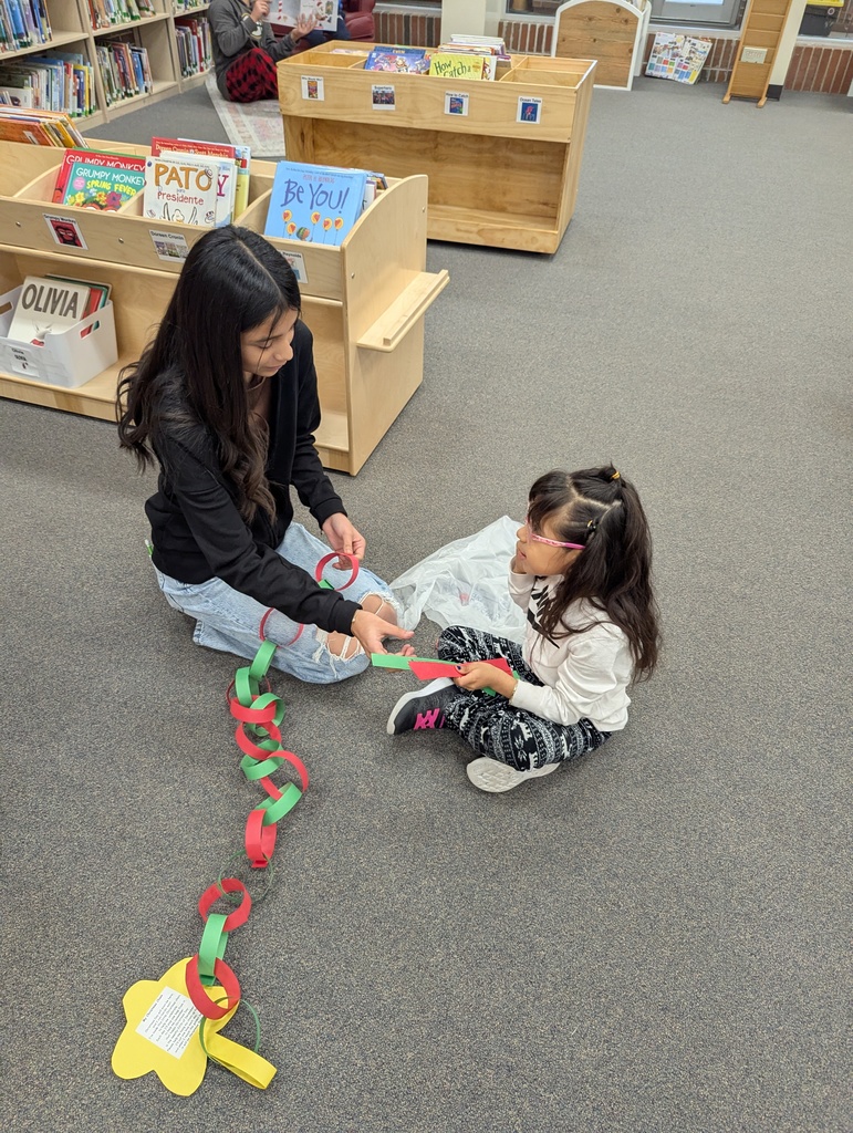 two students making a paper chain