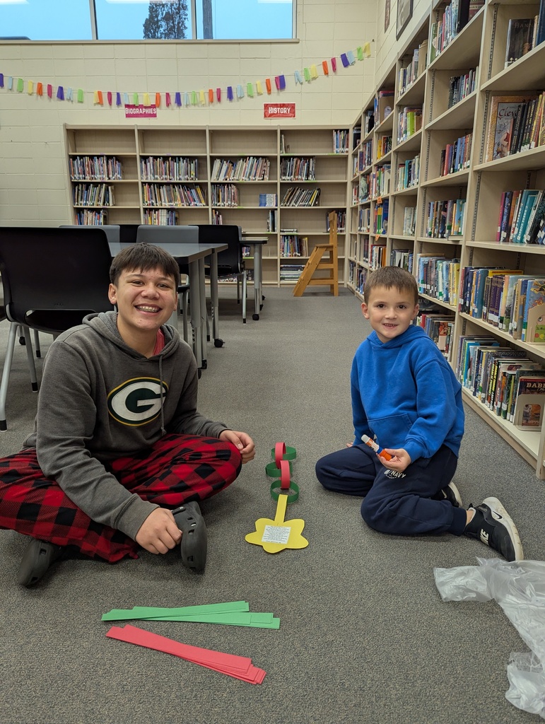 two students making a paper chain