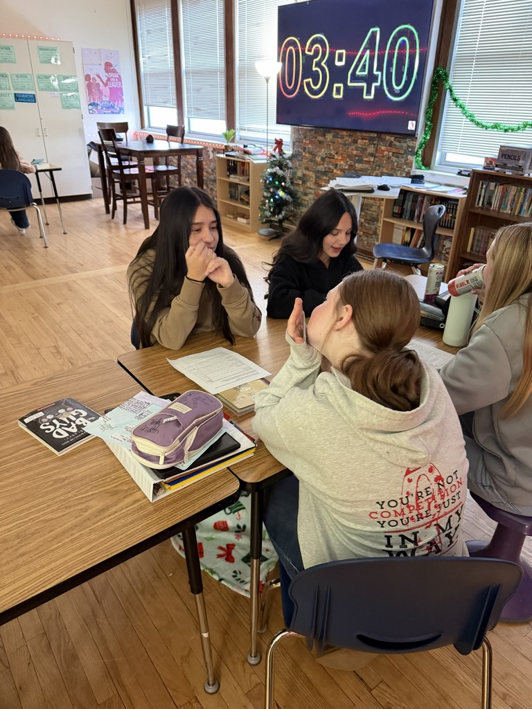 four students at a desk