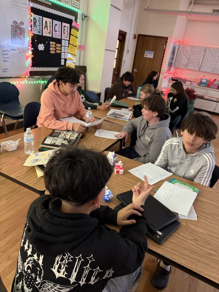 four students at a desk